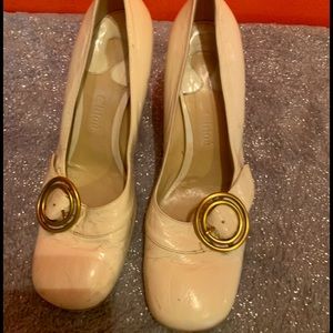 Off white patent leather and brass Mary Janes